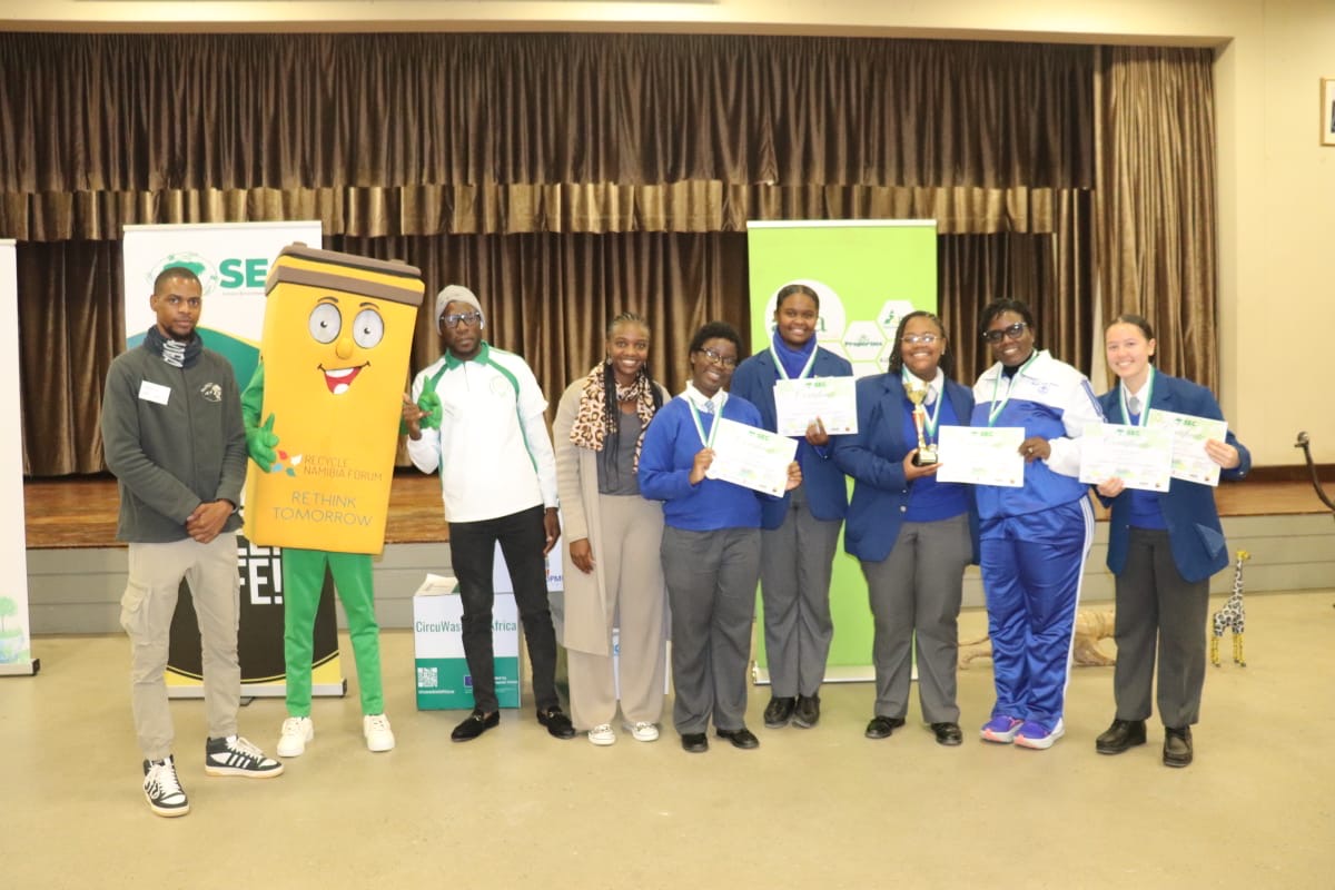 Award winners on stage with SEC staff and the recycling mascot